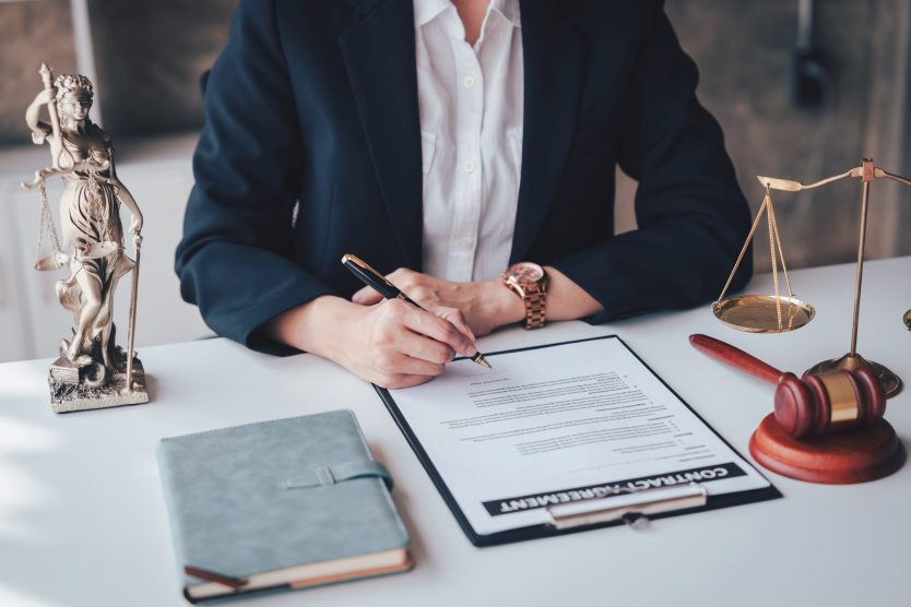 An,Adult,Asian,Woman,Lawyer,Is,Signing,A,Contract,Agreement